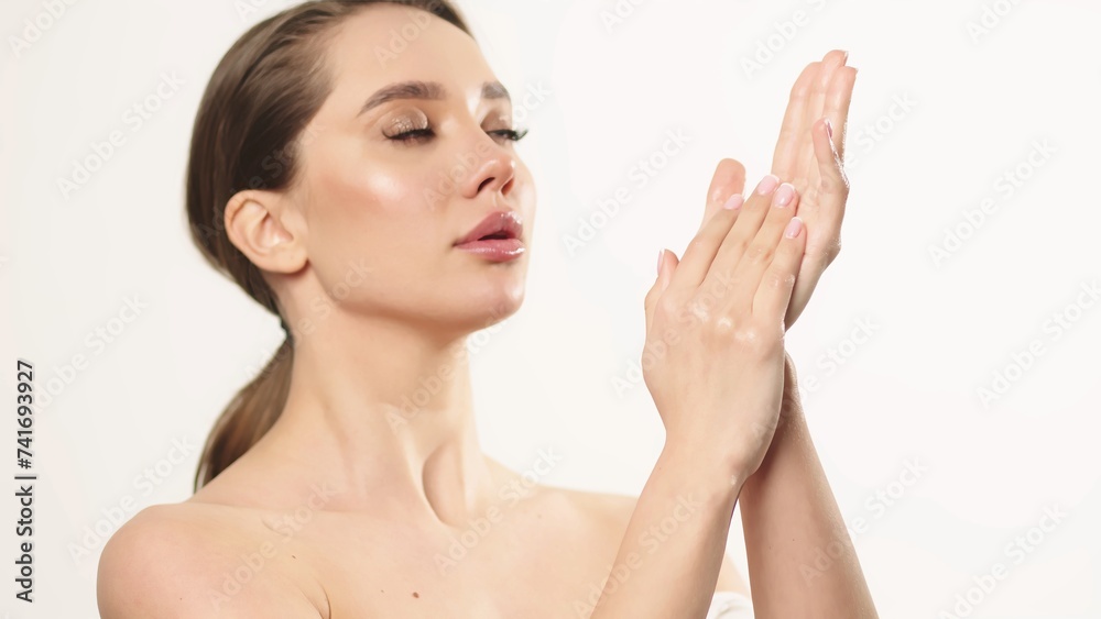 Hand skin care. A young woman with well-groomed, clean skin moisturizes her hands. Close-up of female skin care, cosmetology. Hand skin care. A young woman with well-groomed, clean skin moisturizes her hands. Close-up of female skin care, cosmetology.