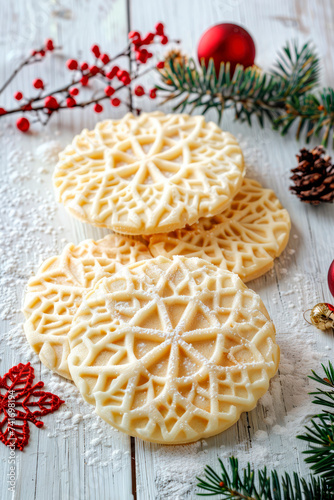 Traditional Italian pizzelle waffle cookies on white wooden background
