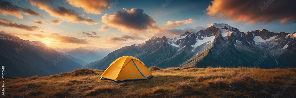 Beautiful early morning camping view. Dolomites sunrise landscape with an orange trekking tent