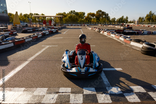 Competitive man racing in go-carts at finish of motor race track © Nomad_Soul