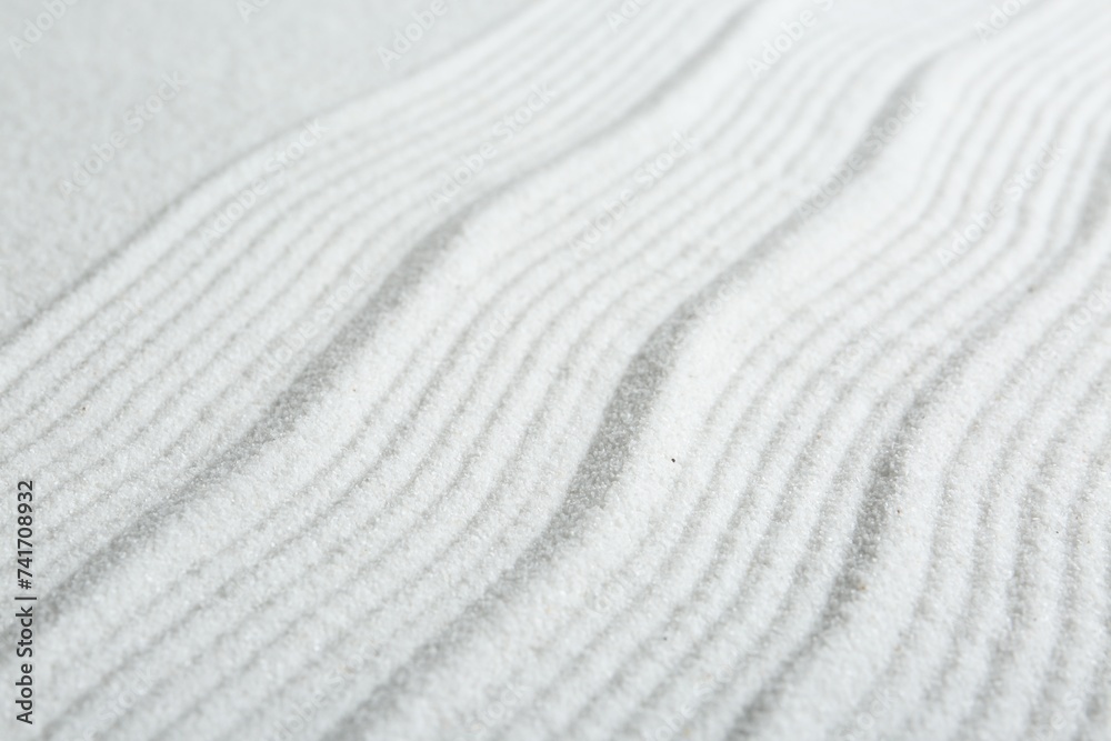 Zen rock garden. Wave pattern on white sand, closeup