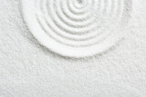 Zen rock garden. Circle pattern on white sand, top view. Space for text