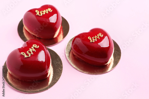 St. Valentine's Day. Delicious heart shaped cakes on light pink background, closeup