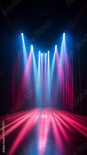 Pink and blue stage lights on a theater stage with a dark background