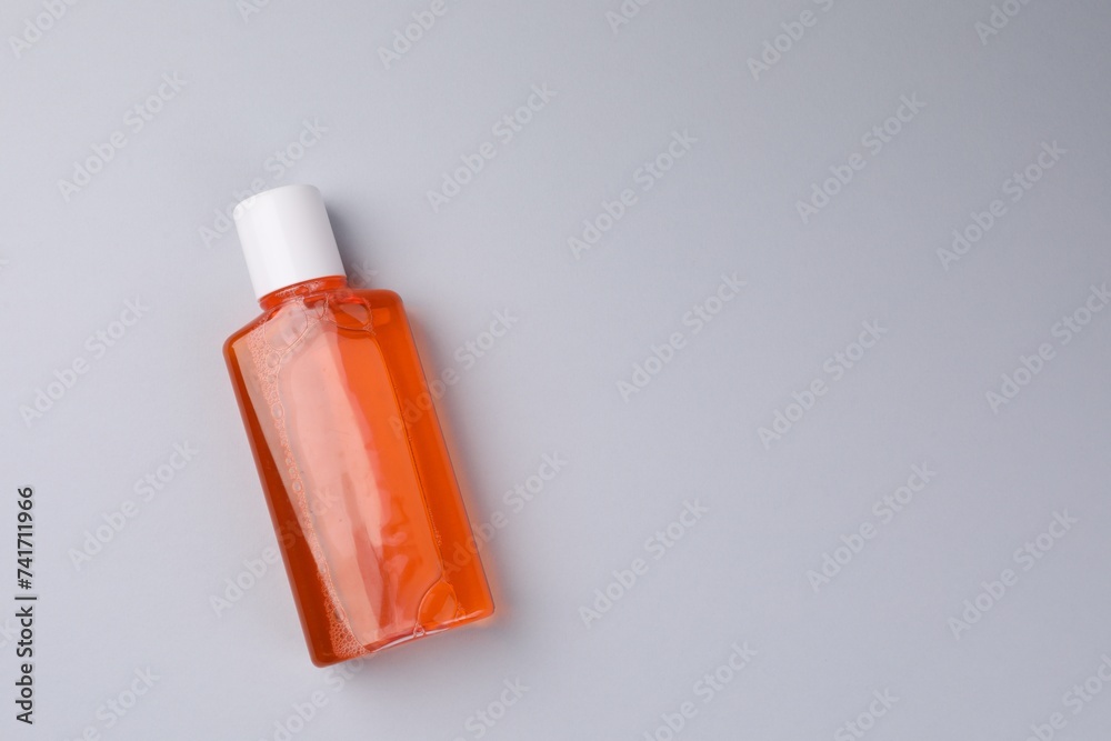 Fresh mouthwash in bottle on grey background, top view. Space for text Fresh mouthwash in bottle on grey background, top view. Space for text