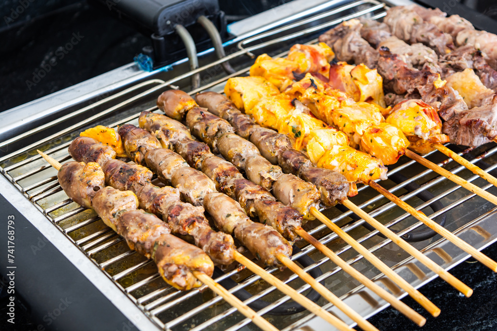 Meat skewer, or brazilian traditional 'espetinho de carne' on a eletric grill