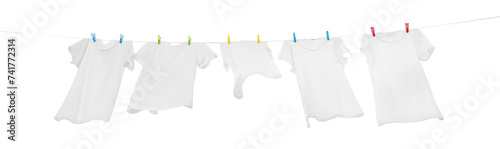 Many t-shirts drying on washing line isolated on white, low angle view