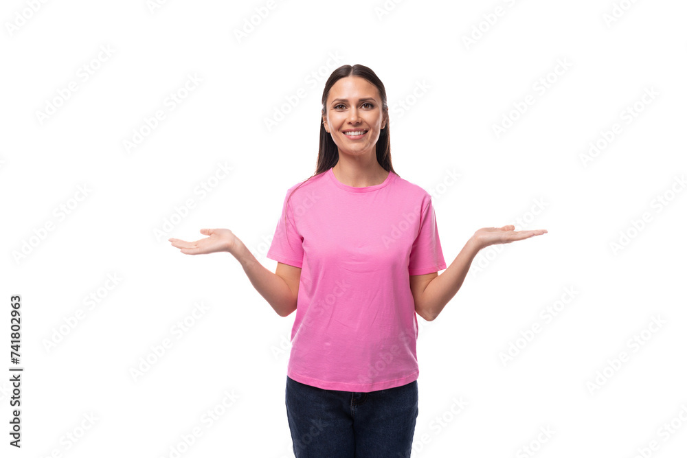 portrait of a young slim brunette woman in a pink basic t-shirt on a white background with copy space portrait of a young slim brunette woman in a pink basic t-shirt on a white background with copy space