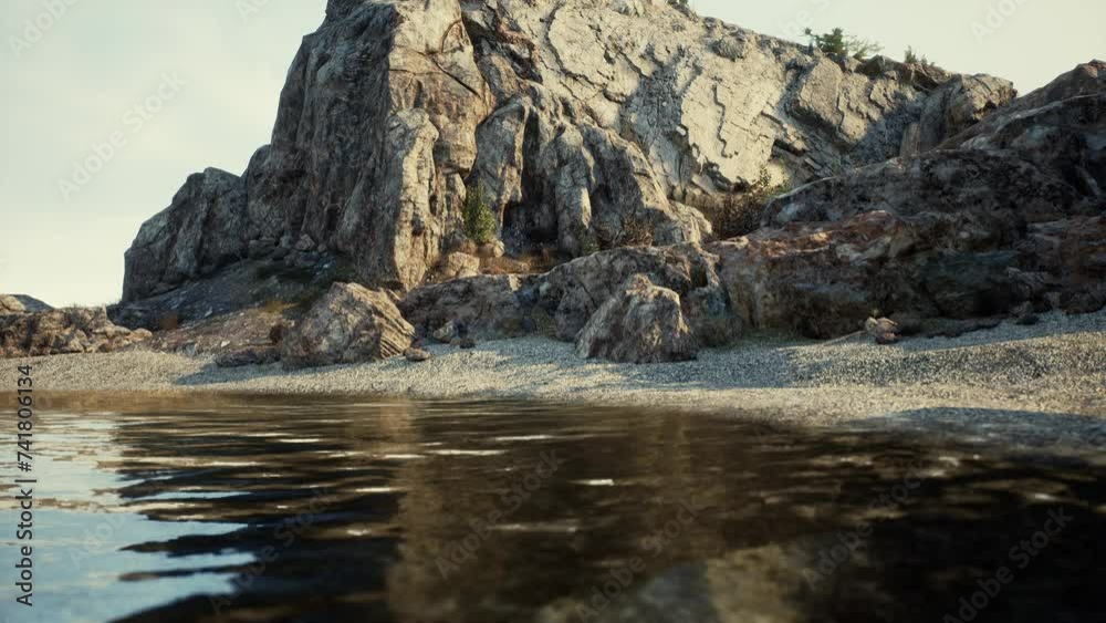 A breathtaking view of a rocky mountain cliff in Spain, adorned by a tranquil body of water in the foreground. A breathtaking view of a rocky mountain cliff in Spain, adorned by a tranquil body of water in the foreground.