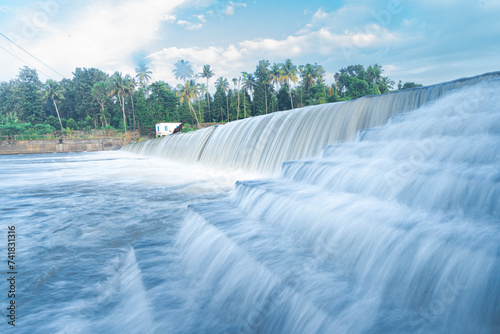 A beautiful view of a waterfall from a check dam In Kerala, India. photo