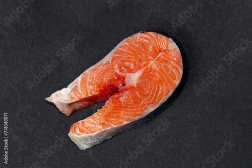 Fresh raw salmon , trout, steak on dark background. Slice of fresh raw fish.