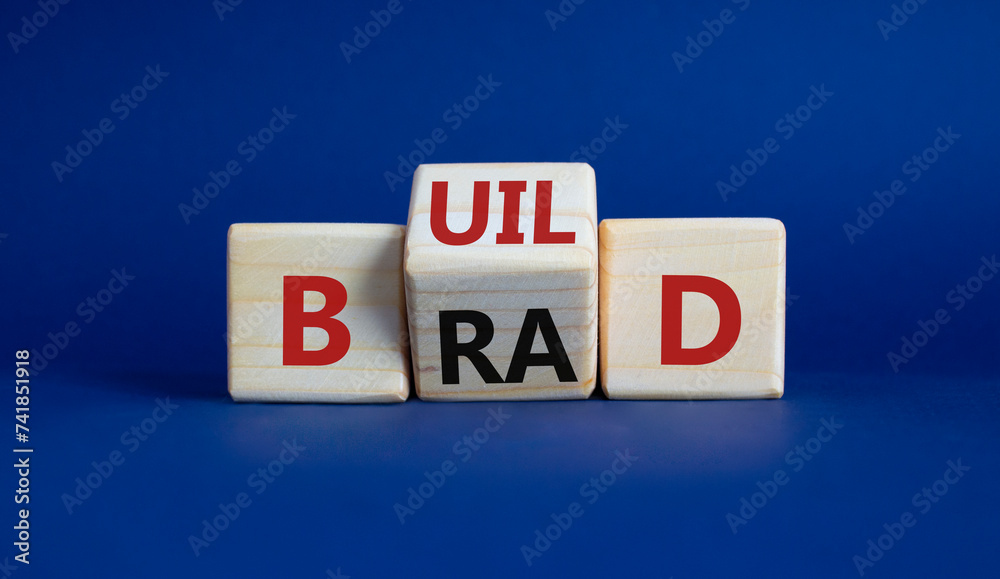 Build your brand symbol. Wooden cubes with words Build and Brand. Beautiful deep blue background. Build your brand and business concept. Copy space Build your brand symbol. Wooden cubes with words Build and Brand. Beautiful deep blue background. Build your brand and business concept. Copy space