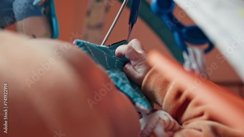 The baby's inquisitive gaze is focused on a captivating toy, grasping it with tiny, determined fingers. The moment is a snapshot of early development, showcasing the baby's budding motor skills and photo