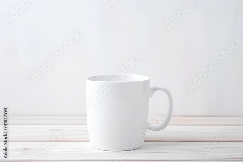 A blank white coffee mug on a soft wooden surface with space for text. White Coffee Mug on Wooden Background