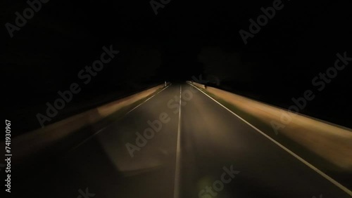 Driver personal perspective driving lonely on a dark road at night time lapse photo