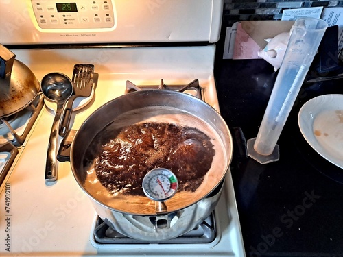 Boiling sap on the kitchen stove to make homemade maple syrup.
