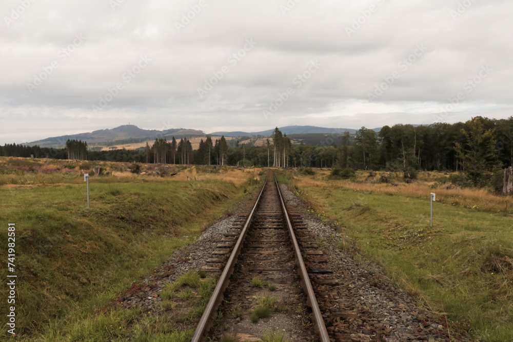 Fototapeta premium Landscape with old railroad railway leading lines in nature rolling hills landscape.