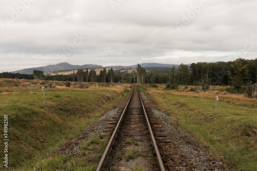 Landscape with old railroad railway leading lines in nature rolling hills landscape.