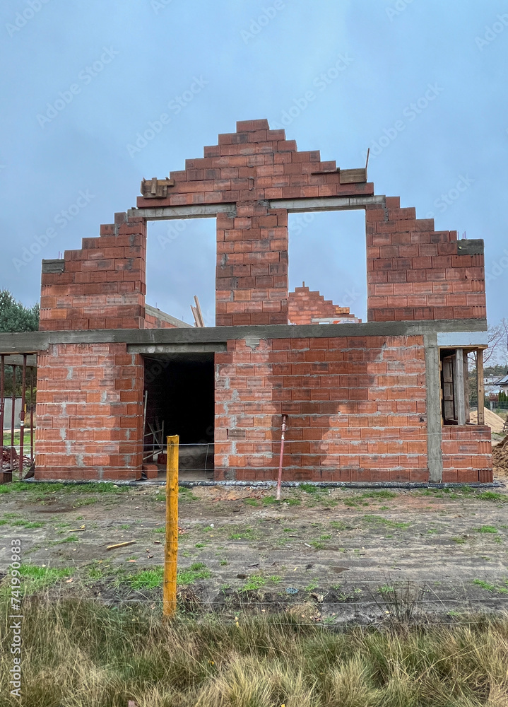 Fototapeta premium Construction of a house using slotted brick technology in autumn and winter conditions