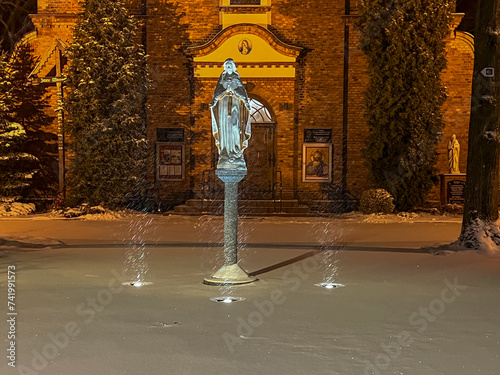 Parish church of St. Francis of Assisi in Kalety Miotek in winter, early in the morning during snowfall photo