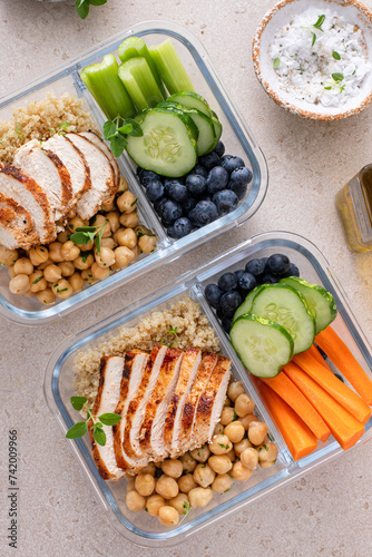 Meal prep containers with healthy food prepped, cooked chicken, quinoa, chickpeas and eggs