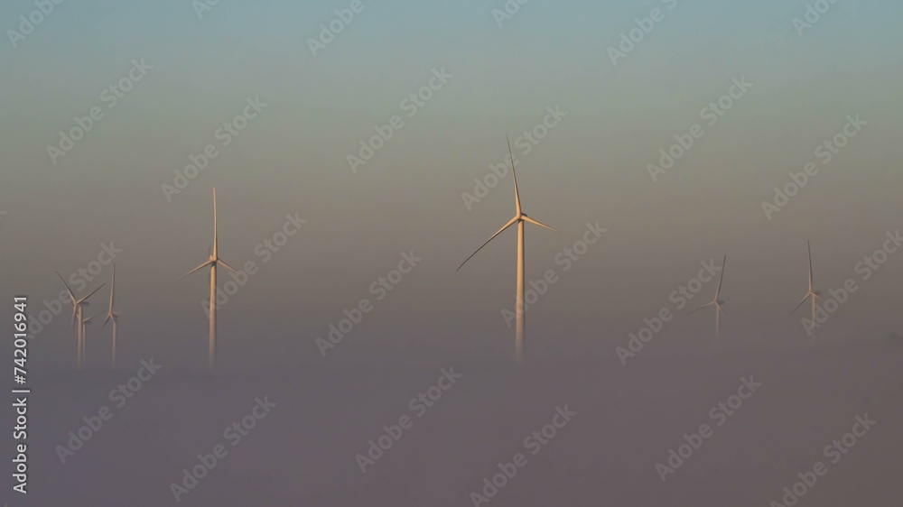 Wind turbines rising out of the fog, Nazare, Portugal, Europe Wind turbines rising out of the fog, Nazare, Portugal, Europe