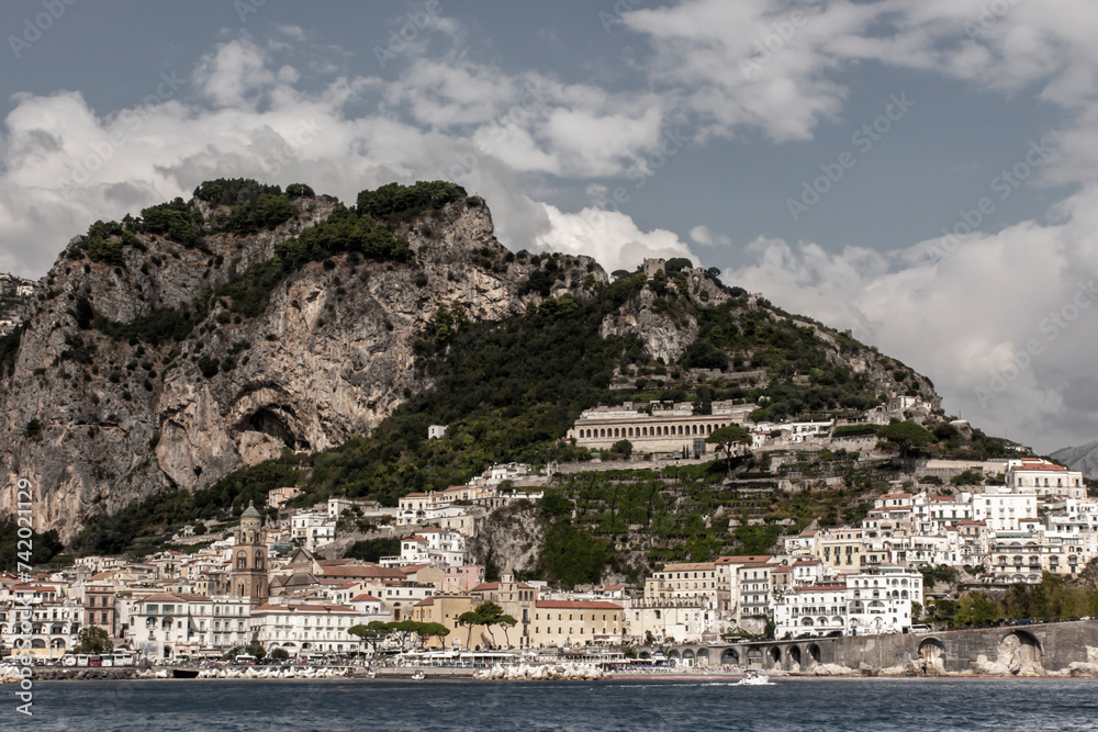 Amalfi, Italy, September 26, 2023: View from the sea of beautifully situated buildings on the slopes of the mountains in Amalfi, Campania, Italy
