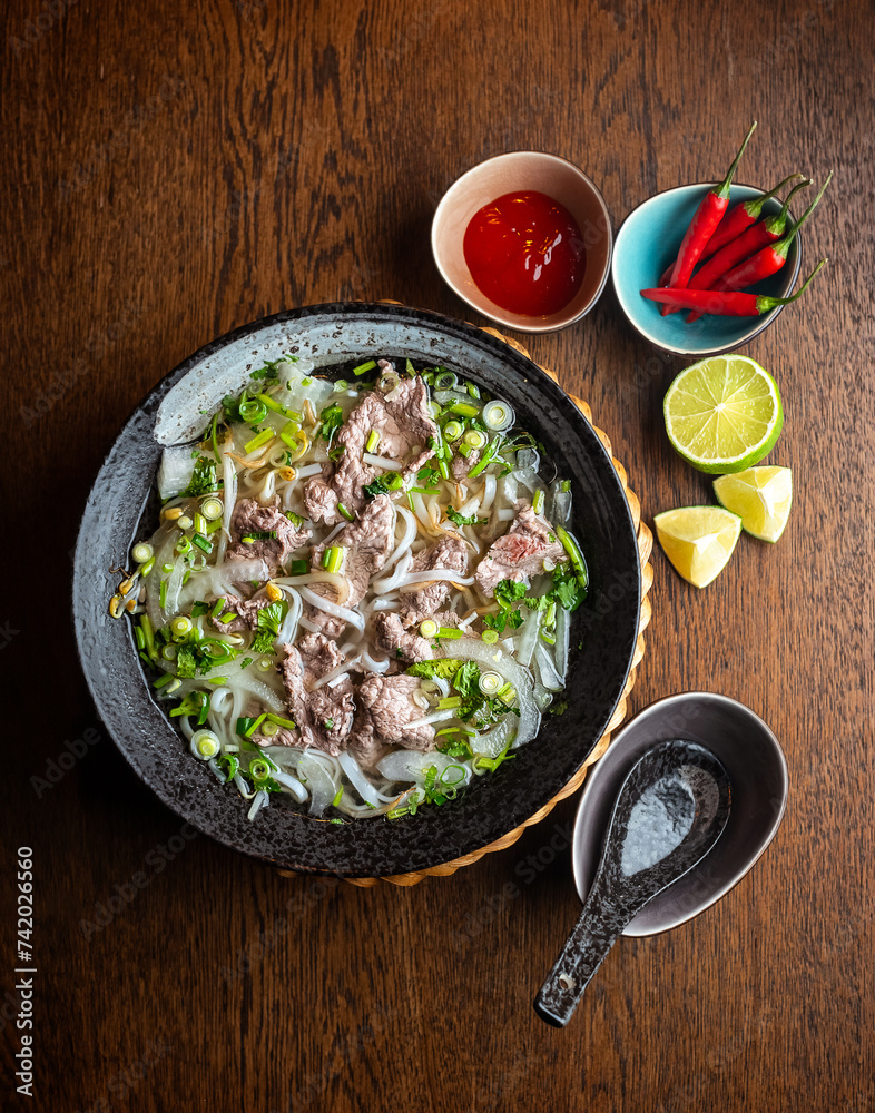 Asian beef soup in a black ceramic plate
