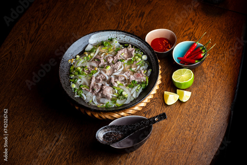 Asian beef soup in a black ceramic plate