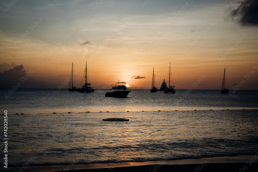 Tropical Pastel Island Sunset with Boats over the ocean in Saint Lucia in the Caribbean Tropical Pastel Island Sunset with Boats over the ocean in Saint Lucia in the Caribbean