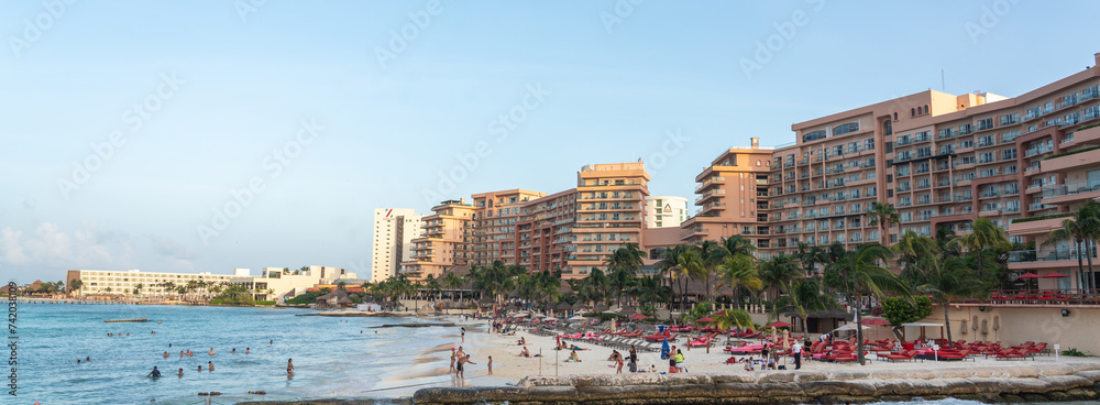 Blurry image of a beach with buildings by the water