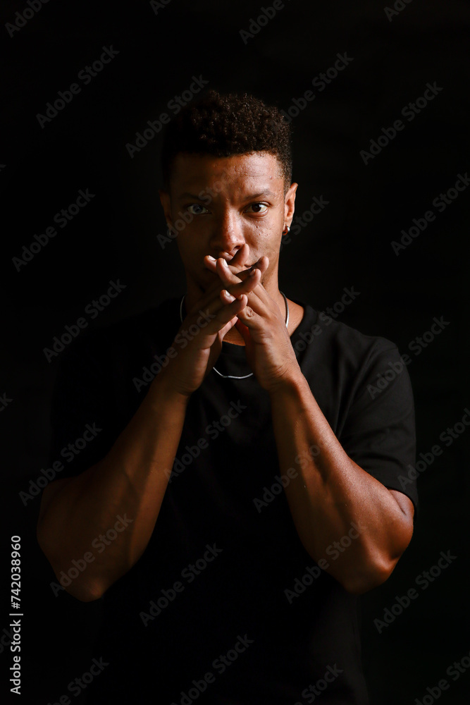 Low key portrait of young African man thinking