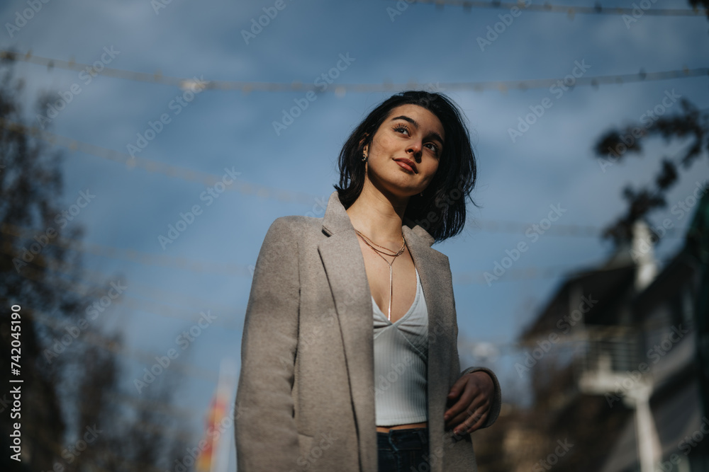 Fashionable teenage girl enjoying a walk in the city during autumn.