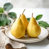 Ripe pears on a white plate,blured background, close-up, space for text