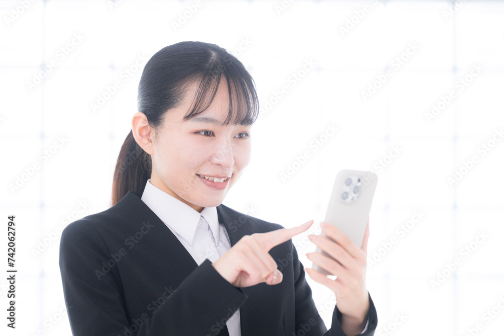 Businesswoman operating a cell phone Smiling woman Businesswoman operating a cell phone Smiling woman