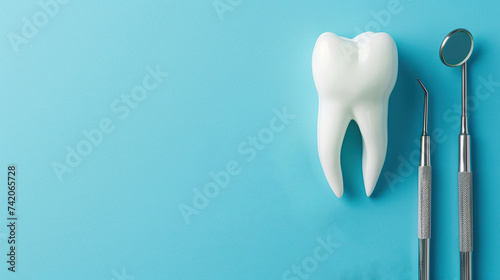 Tooth and dental tools on pastel blue background, dentist treatment, dentist mirror, hook