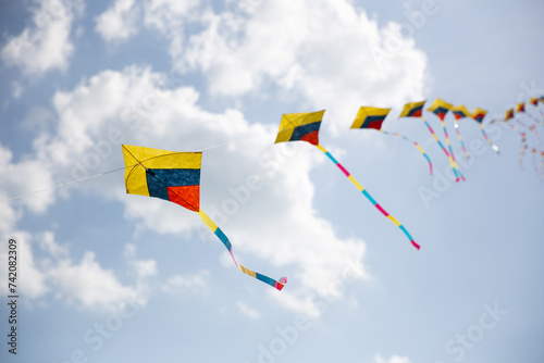 Colorful Kites in Sync flying photo