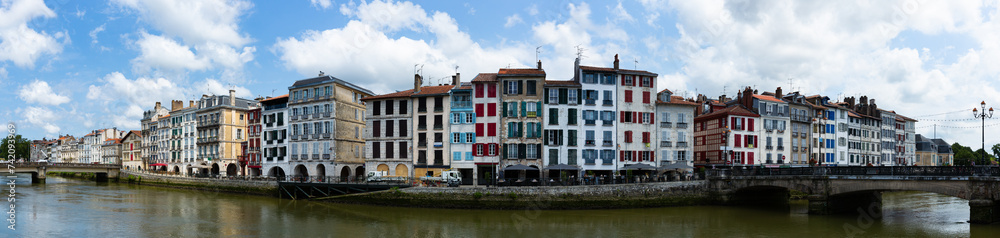 Panoramic scenic view of old houses at quay of Nive river in Bayonne, France