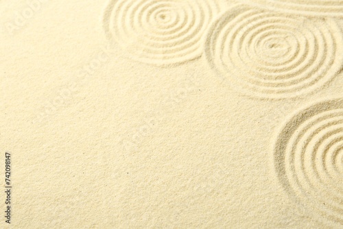 Zen rock garden. Circle patterns on beige sand