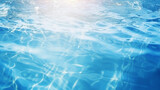 Defocused blurred transparent blue colored clear calm water surface texture with splashes