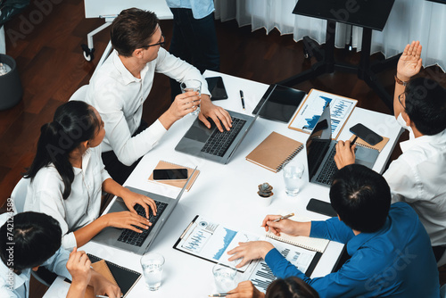 Analyst team utilizing BI Fintech to analyze financial data at table in meeting room. Businesspeople analyzing BI dashboard power on paper for business insight and strategic marketing planning.Prudent