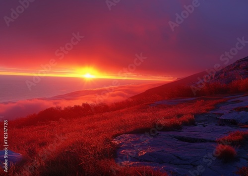 Fiery Sunset Over Mountainous Landscape with Snow Patches