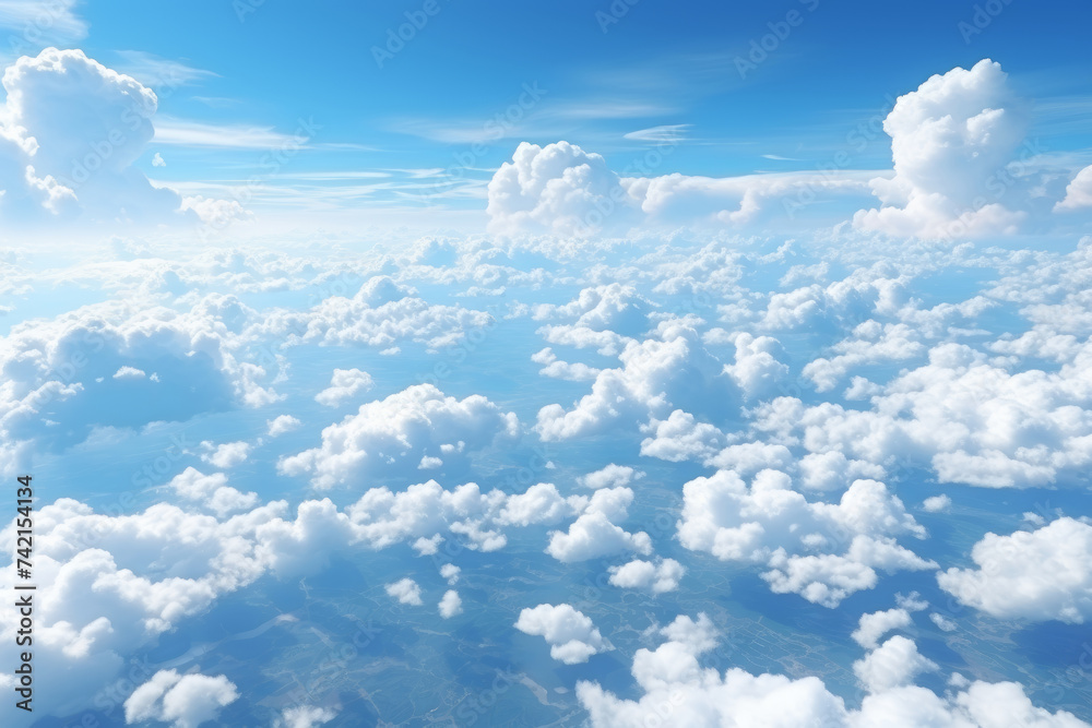 Beautiful cumulus white clouds against turquoise blue sky from airplane in sunny weather