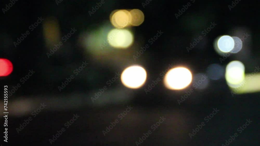 Traffic light in the night street. Background car and motorbike lights. Abstract blurred light of car and motorbike. Bokeh footage. Traffic light in the night street. Background car and motorbike lights. Abstract blurred light of car and motorbike. Bokeh footage.