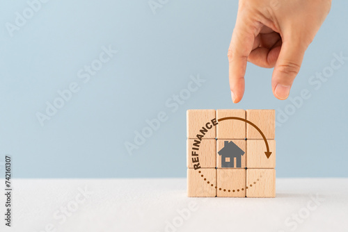 house icon inside refinance text and circle on wooden cube block , copy space included