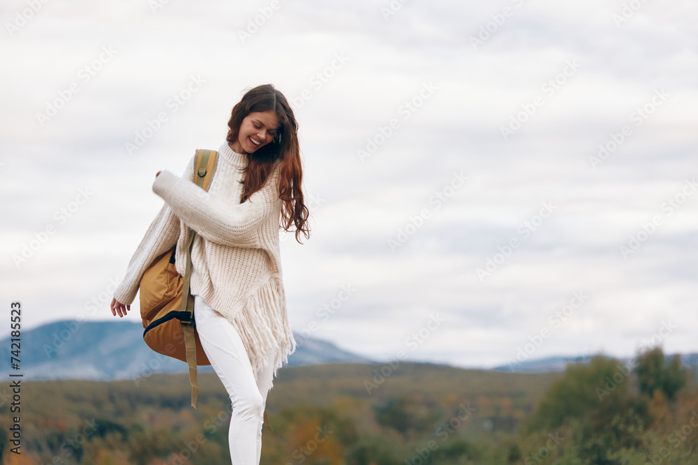 Mountain Adventure: Smiling Woman on Cliff, Embracing Nature and Enjoying Freedom on a Hiking Journey Mountain Adventure: Smiling Woman on Cliff, Embracing Nature and Enjoying Freedom on a Hiking Journey
