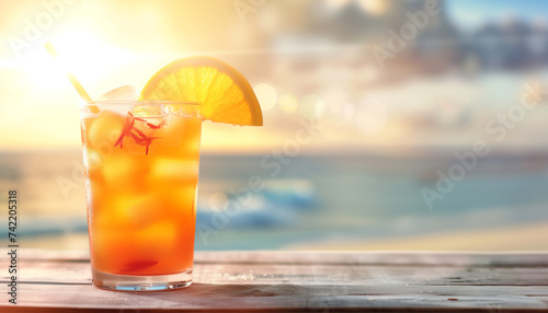 Refreshing tropical hurricane cocktail on beach with blurred background
