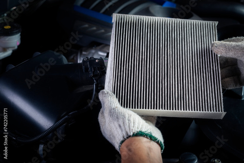 Car air conditioner system maintenance, Hand mechanic holding car air filter to check for clean dirty or fix repair heat have a problem or replace new or change filter.