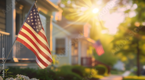 American flag displayed on house corner with blurred background