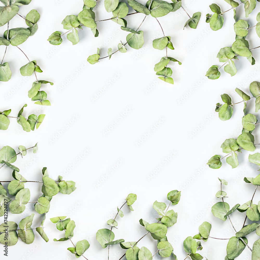 Green leaves frame on a white background. Copy space.